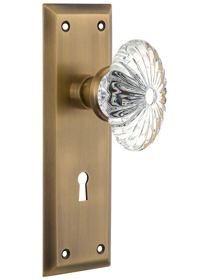 New York Plate with Oval Fluted Crystal Knob with Keyhole in Antique Brass.